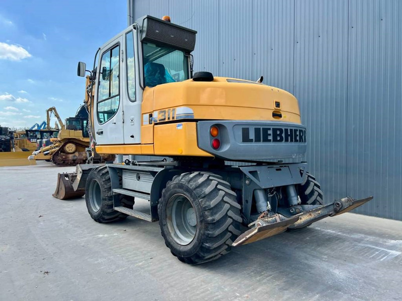 Liebherr A 311 Litronic - Pelle sur pneus: photos 2 Liebherr A 311 Litronic - Pelle sur pneus: photos 2