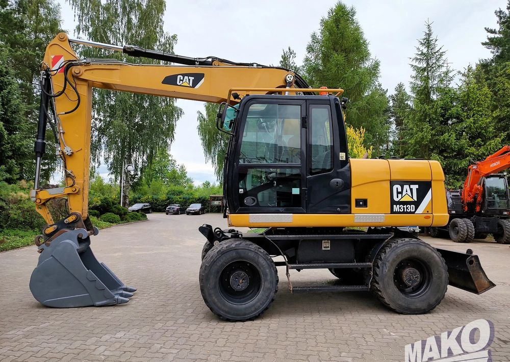 Caterpillar M313D - Pelle sur pneus: photos 1 Caterpillar M313D - Pelle sur pneus: photos 1