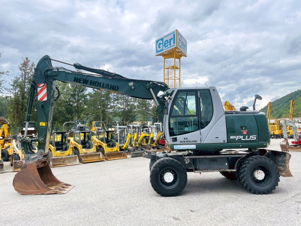New Holland MH Plus (4054) - Pelle sur pneus: photos 1 New Holland MH Plus (4054) - Pelle sur pneus: photos 1