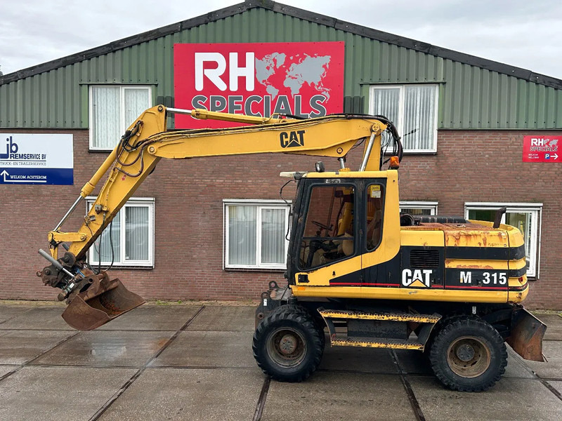 Caterpillar M315 +ROTO CE - Pelle sur pneus: photos 1 Caterpillar M315 +ROTO CE - Pelle sur pneus: photos 1